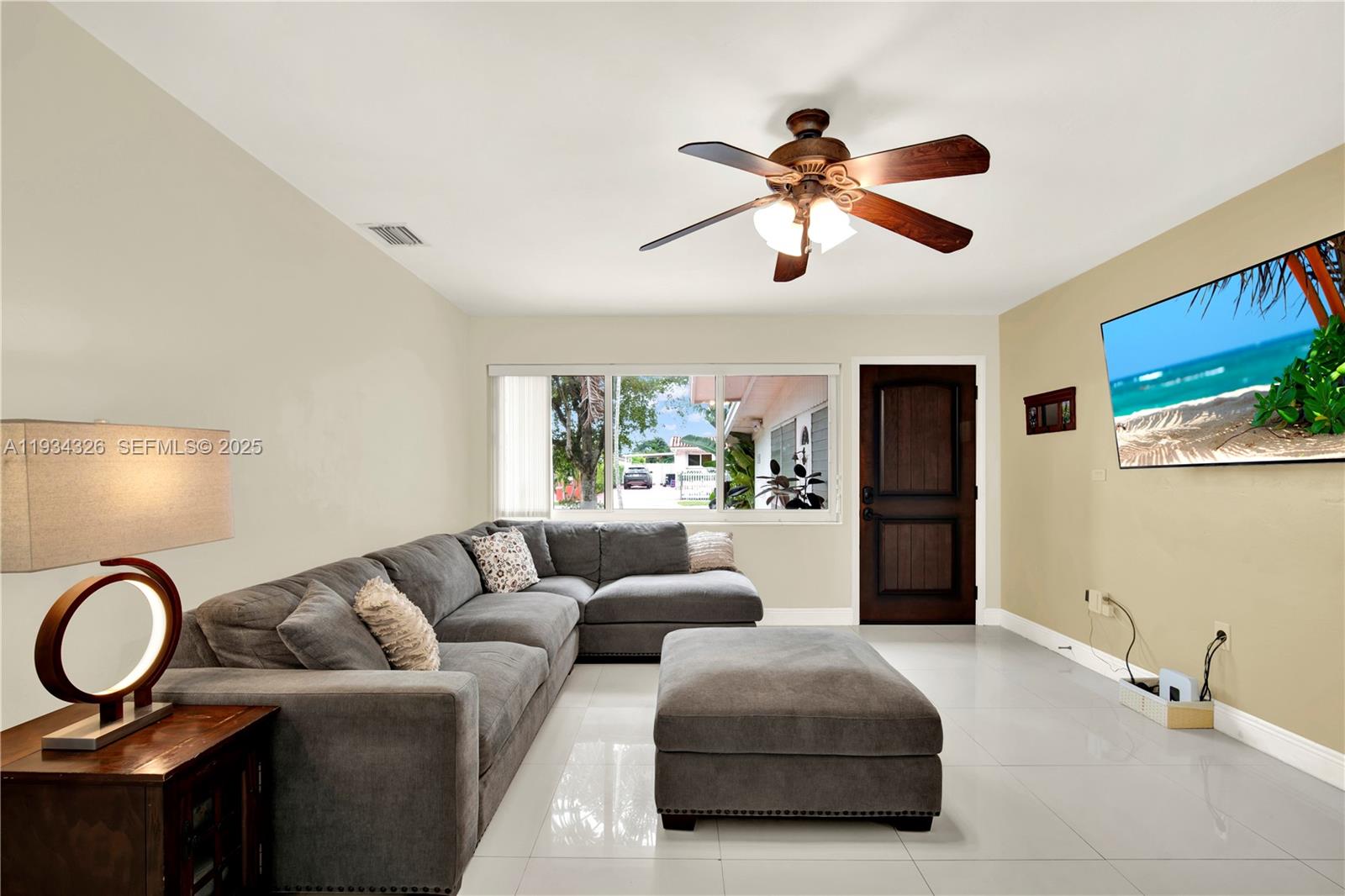 7135 Southwest 19th Terrace Miami, FL 33155 - Photo 9 of 52 a living room with furniture a ceiling fan and a window