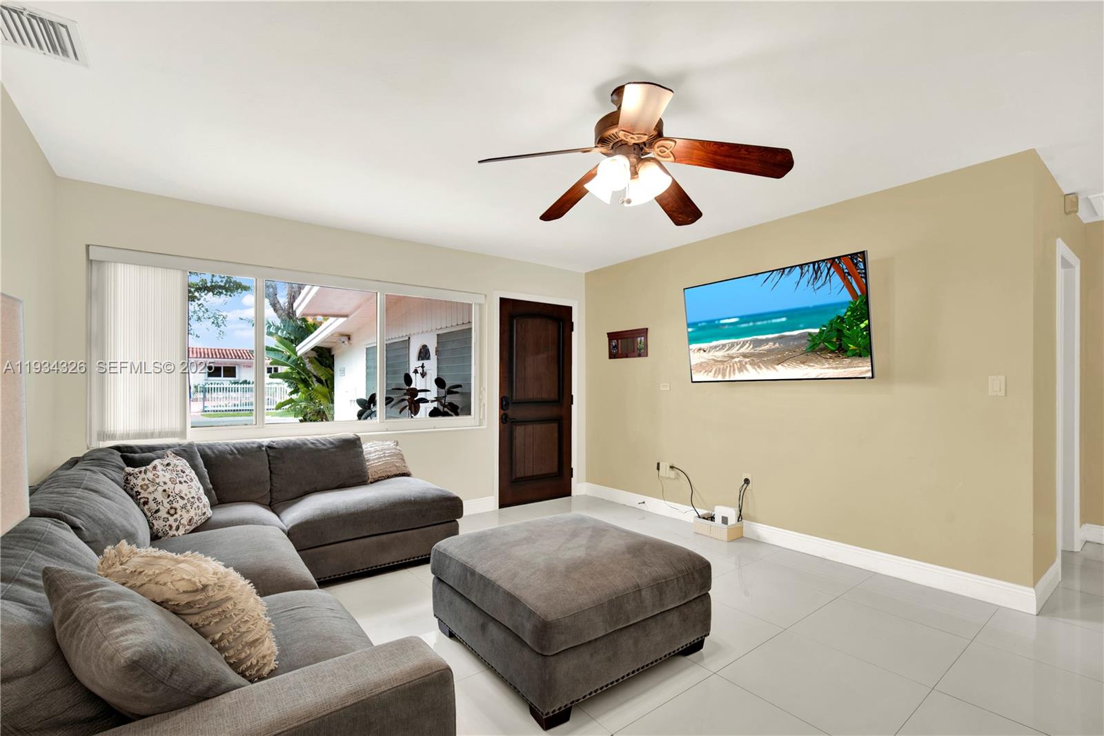 7135 Southwest 19th Terrace Miami, FL 33155 - Photo 10 of 52 a living room with furniture and a large window