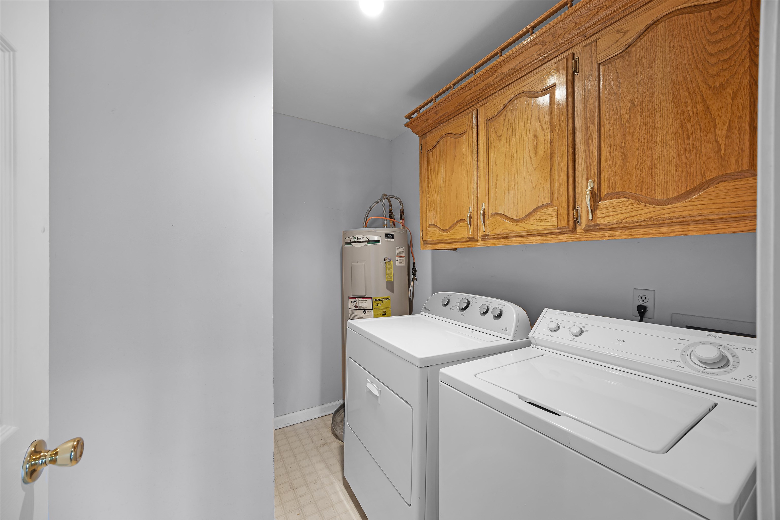 80 Riviera Cove Cherokee, AL 35616 - Photo 21 of 31 Laundry room with washing machine and dryer, electric water heater, light floors, and cabinet space