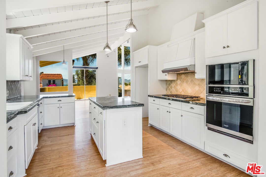224 Sunridge Street Playa del Rey, CA 90293 - Photo 13 of 44 a kitchen with stainless steel appliances granite countertop a stove a sink and a refrigerator