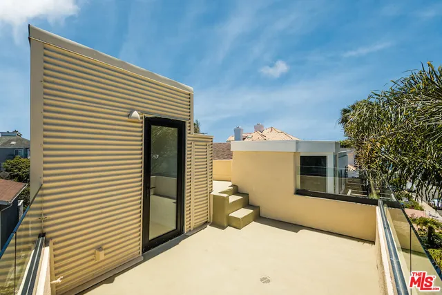 a view of a house with a balcony and door