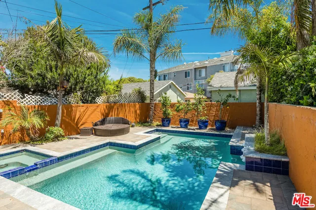 a view of a patio with chairs and potted plants