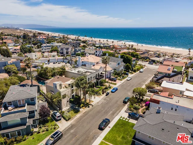 an aerial view of a houses with a yard