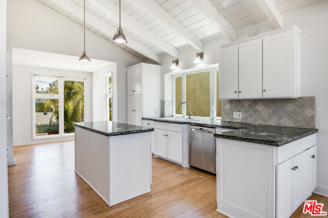 224 Sunridge Street Playa del Rey, CA 90293 - Photo 7 of 44 a kitchen with granite countertop a sink and cabinets