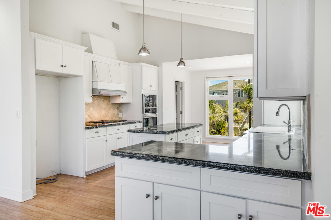 224 Sunridge Street Playa del Rey, CA 90293 - Photo 10 of 44 a kitchen with stainless steel appliances granite countertop a sink a stove and a refrigerator