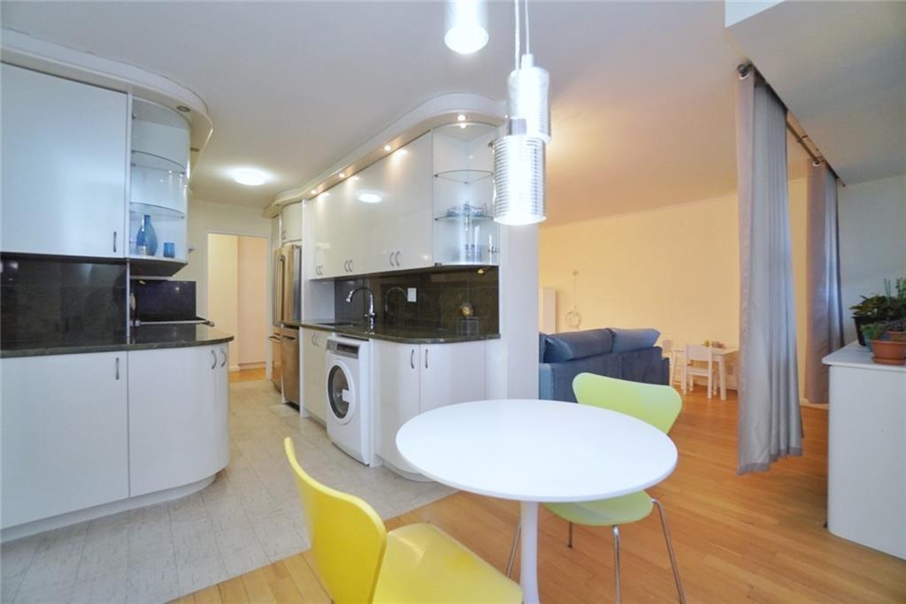 35 Seacoast Terrace, Unit 2N Brooklyn, NY 11235 - Photo 12 of 38 a living room with furniture and a flat screen tv