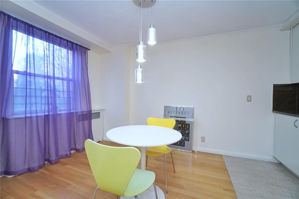 35 Seacoast Terrace, Unit 2N Brooklyn, NY 11235 - Photo 13 of 38 a living room with a table and chairs