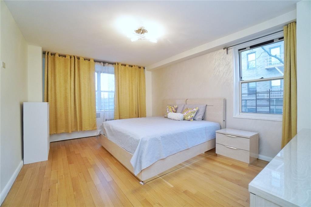 35 Seacoast Terrace, Unit 2N Brooklyn, NY 11235 - Photo 18 of 38 a bedroom with a bed and wooden floor