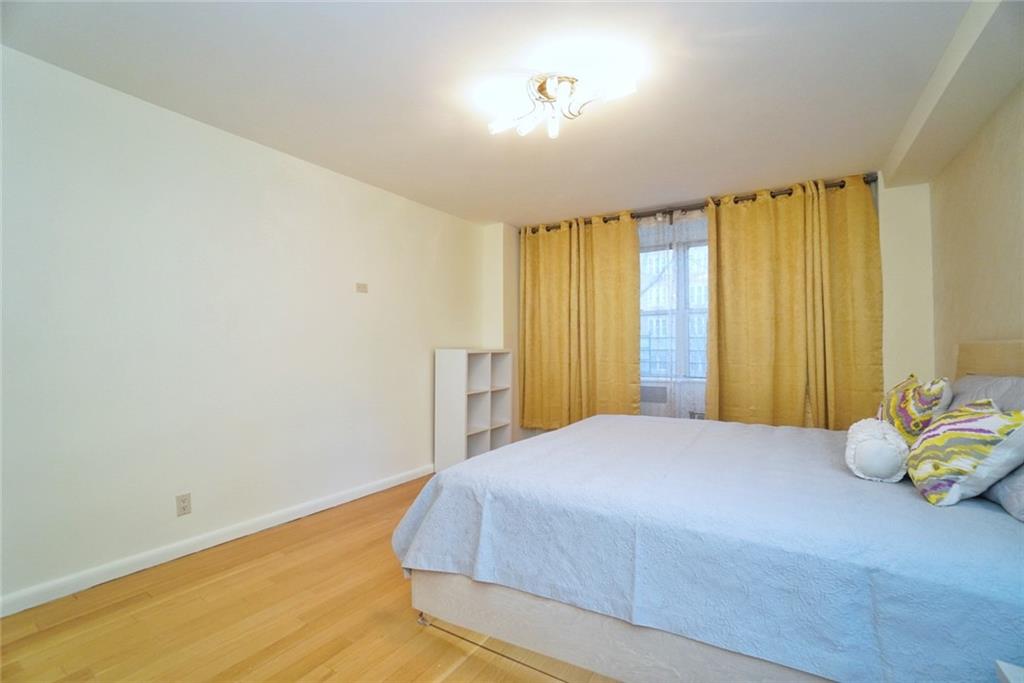 35 Seacoast Terrace, Unit 2N Brooklyn, NY 11235 - Photo 19 of 38 a bedroom with a bed and a window