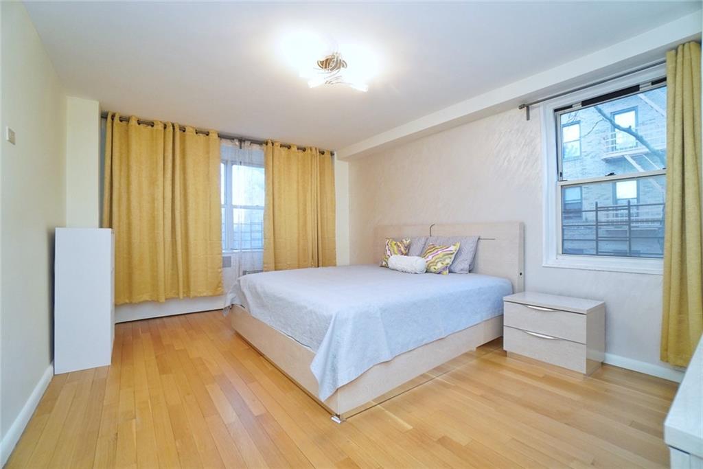 35 Seacoast Terrace, Unit 2N Brooklyn, NY 11235 - Photo 20 of 38 a bedroom with a bed and a large window