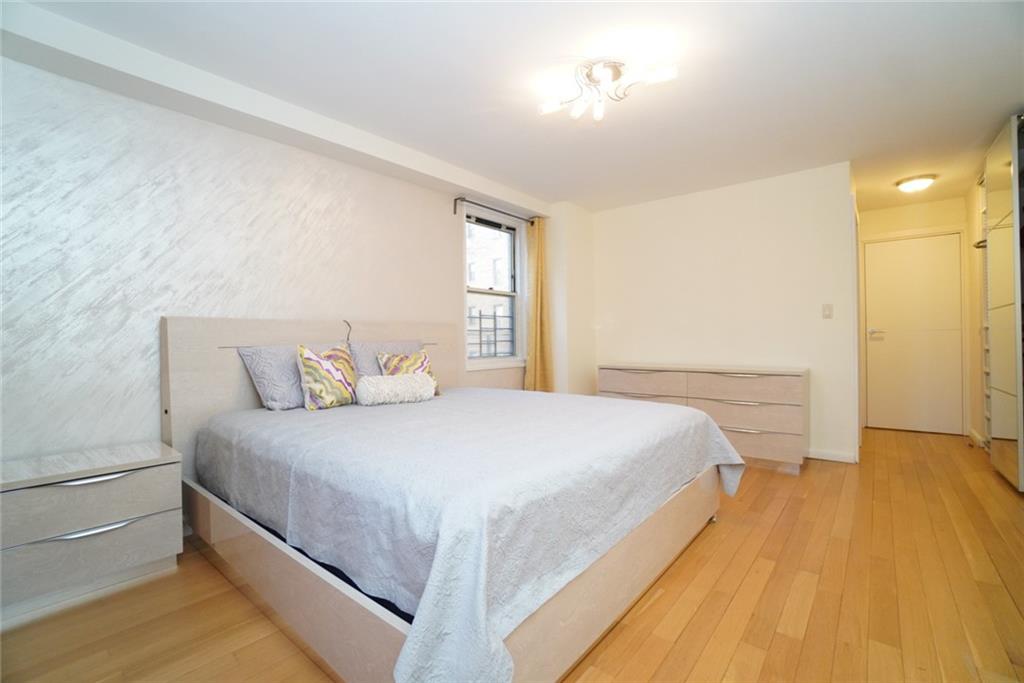 35 Seacoast Terrace, Unit 2N Brooklyn, NY 11235 - Photo 21 of 38 a bedroom with a bed and a window