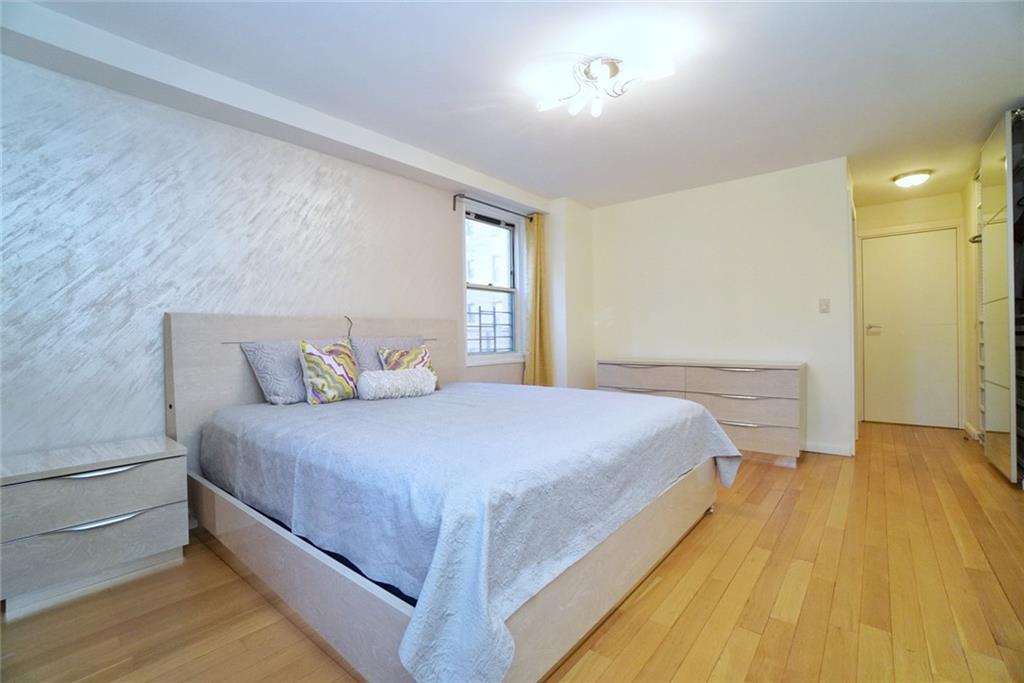 35 Seacoast Terrace, Unit 2N Brooklyn, NY 11235 - Photo 22 of 38 a bedroom with a bed and window