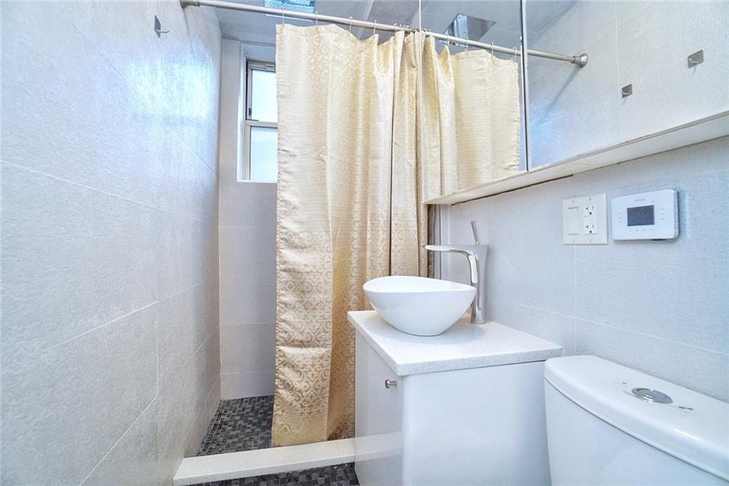 35 Seacoast Terrace, Unit 2N Brooklyn, NY 11235 - Photo 24 of 38 a bathroom with a sink toilet and shower