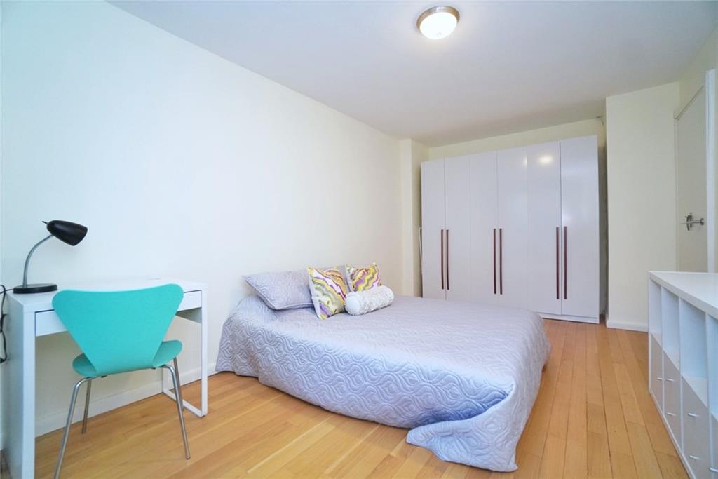 35 Seacoast Terrace, Unit 2N Brooklyn, NY 11235 - Photo 27 of 38 a bedroom with a bed and chair