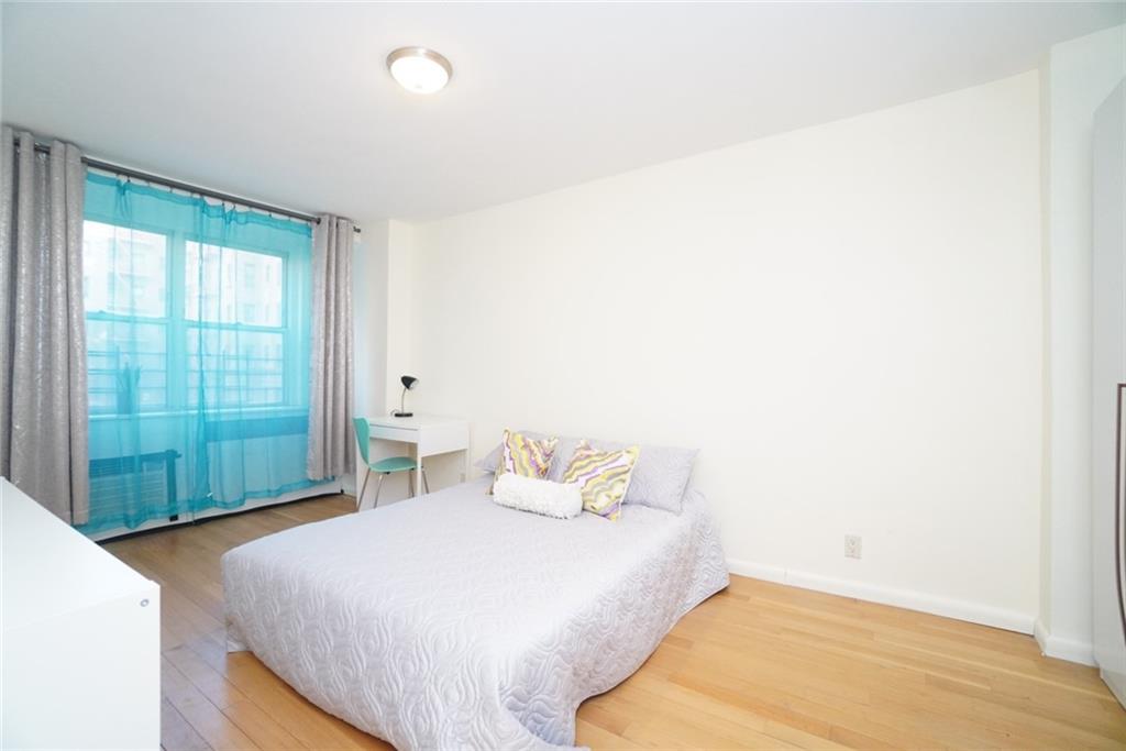 35 Seacoast Terrace, Unit 2N Brooklyn, NY 11235 - Photo 28 of 38 a bedroom with a bed and a window