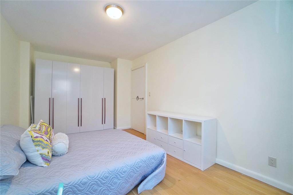 35 Seacoast Terrace, Unit 2N Brooklyn, NY 11235 - Photo 29 of 38 a bedroom with a bed and a window
