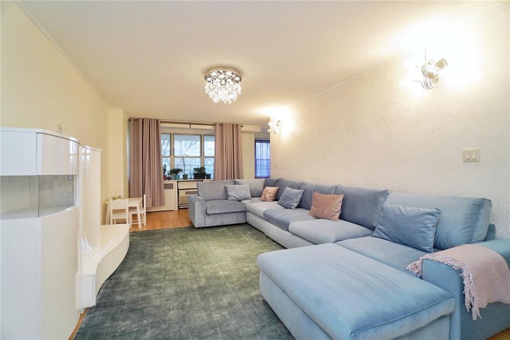 35 Seacoast Terrace, Unit 2N Brooklyn, NY 11235 - Photo 7 of 38 a living room with furniture and a large window