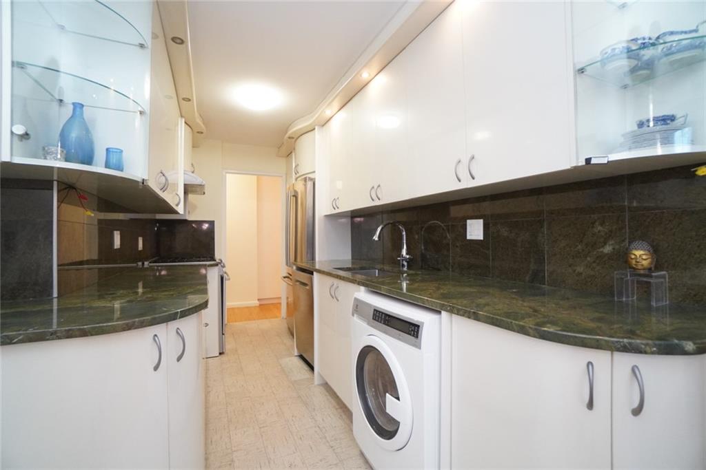 35 Seacoast Terrace, Unit 2N Brooklyn, NY 11235 - Photo 8 of 38 a kitchen with stainless steel appliances granite countertop a sink a stove and oven