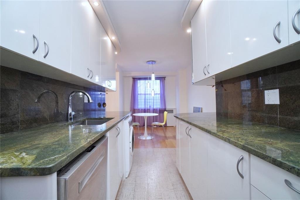 35 Seacoast Terrace, Unit 2N Brooklyn, NY 11235 - Photo 9 of 38 a kitchen with stainless steel appliances granite countertop a sink a counter top space and cabinets