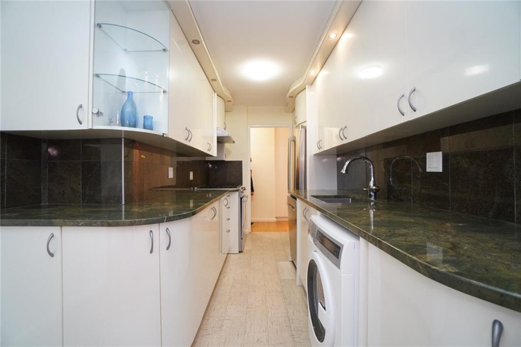 35 Seacoast Terrace, Unit 2N Brooklyn, NY 11235 - Photo 10 of 38 a kitchen with stainless steel appliances granite countertop a sink and a stove