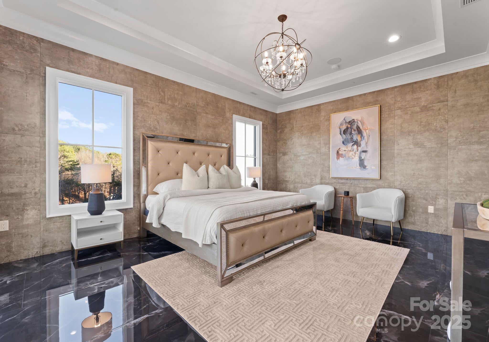 19329 Watermark Drive, Unit 551 Cornelius, NC 28031 - Photo 11 of 25 a bedroom with a bed and a chandelier