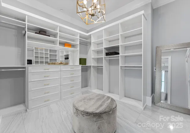 a view of walk in closet and bedroom