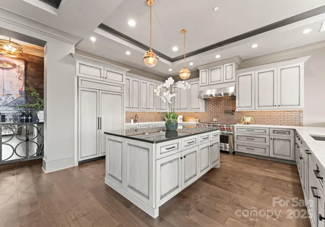 a kitchen with stainless steel appliances granite countertop a stove and a refrigerator