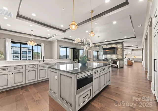 a kitchen with stainless steel appliances granite countertop a stove and a large window