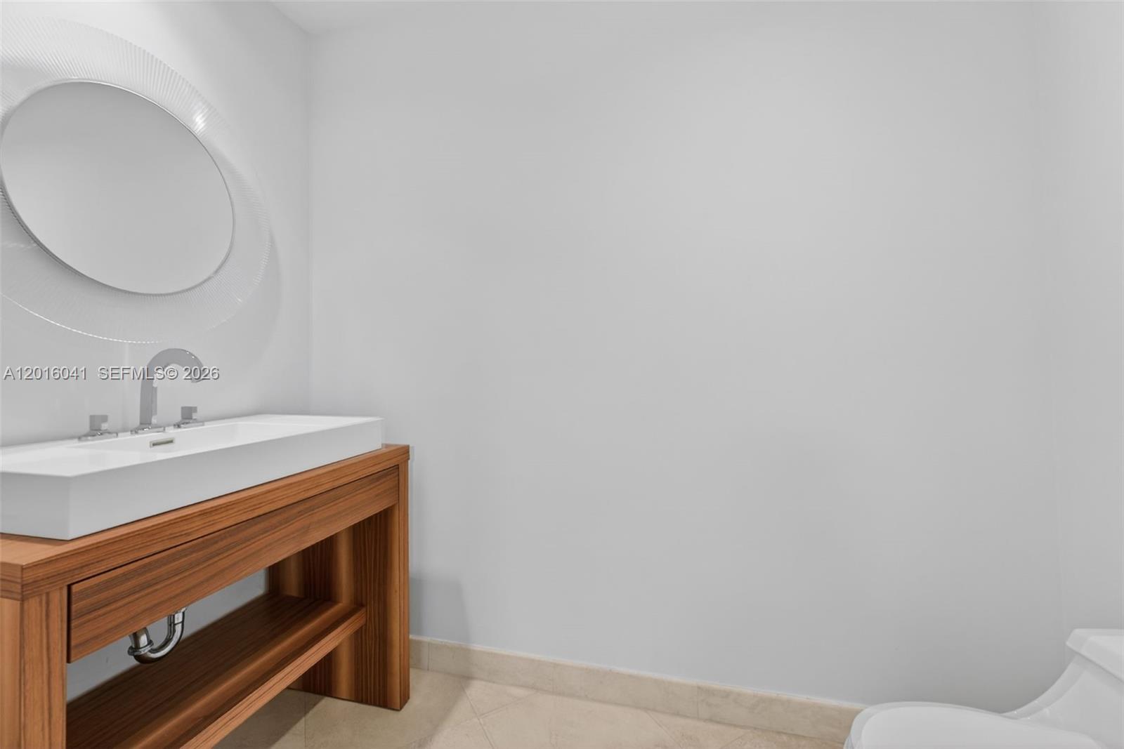 808 Brickell Key Drive, Unit 3304 Miami, FL 33131 - Photo 14 of 70 a bathroom with a sink and a mirror
