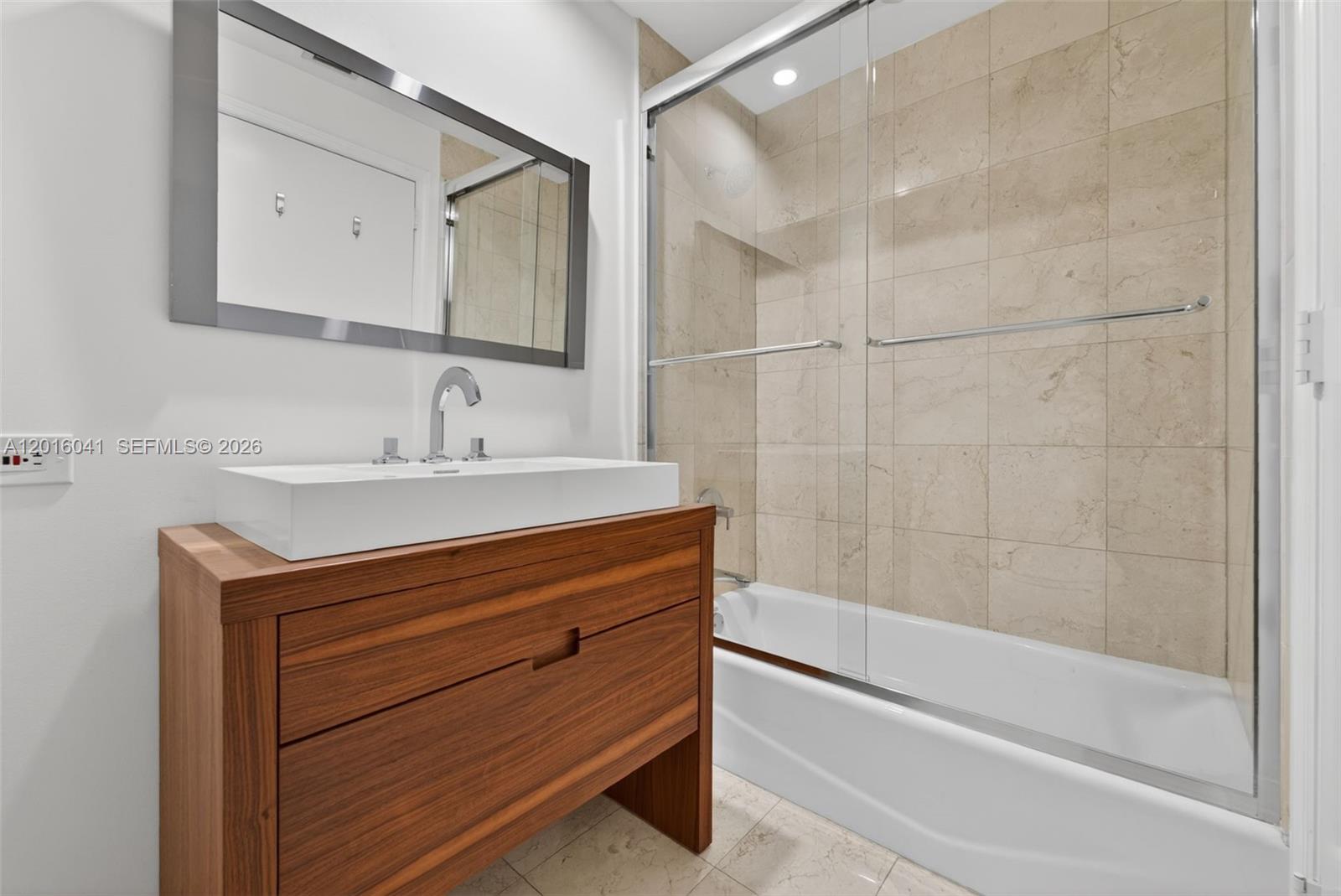 808 Brickell Key Drive, Unit 3304 Miami, FL 33131 - Photo 25 of 70 a bathroom with a sink and a mirror