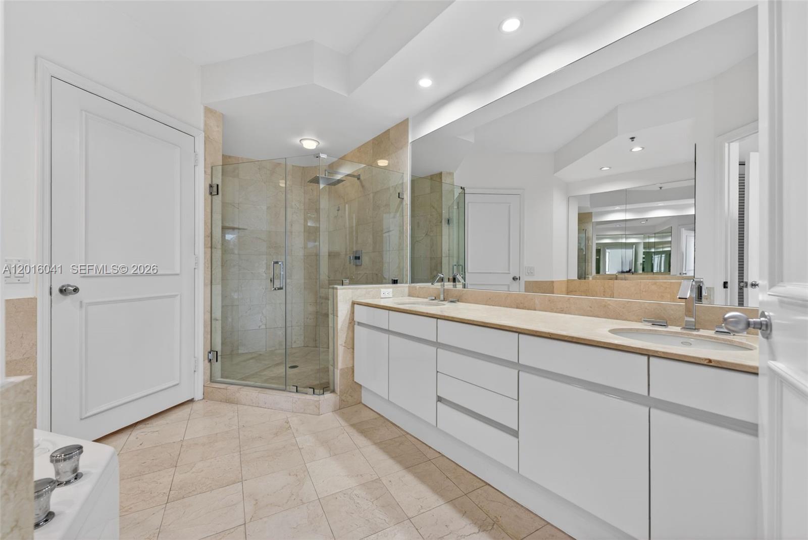 808 Brickell Key Drive, Unit 3304 Miami, FL 33131 - Photo 38 of 70 a bathroom with double sink and a shower