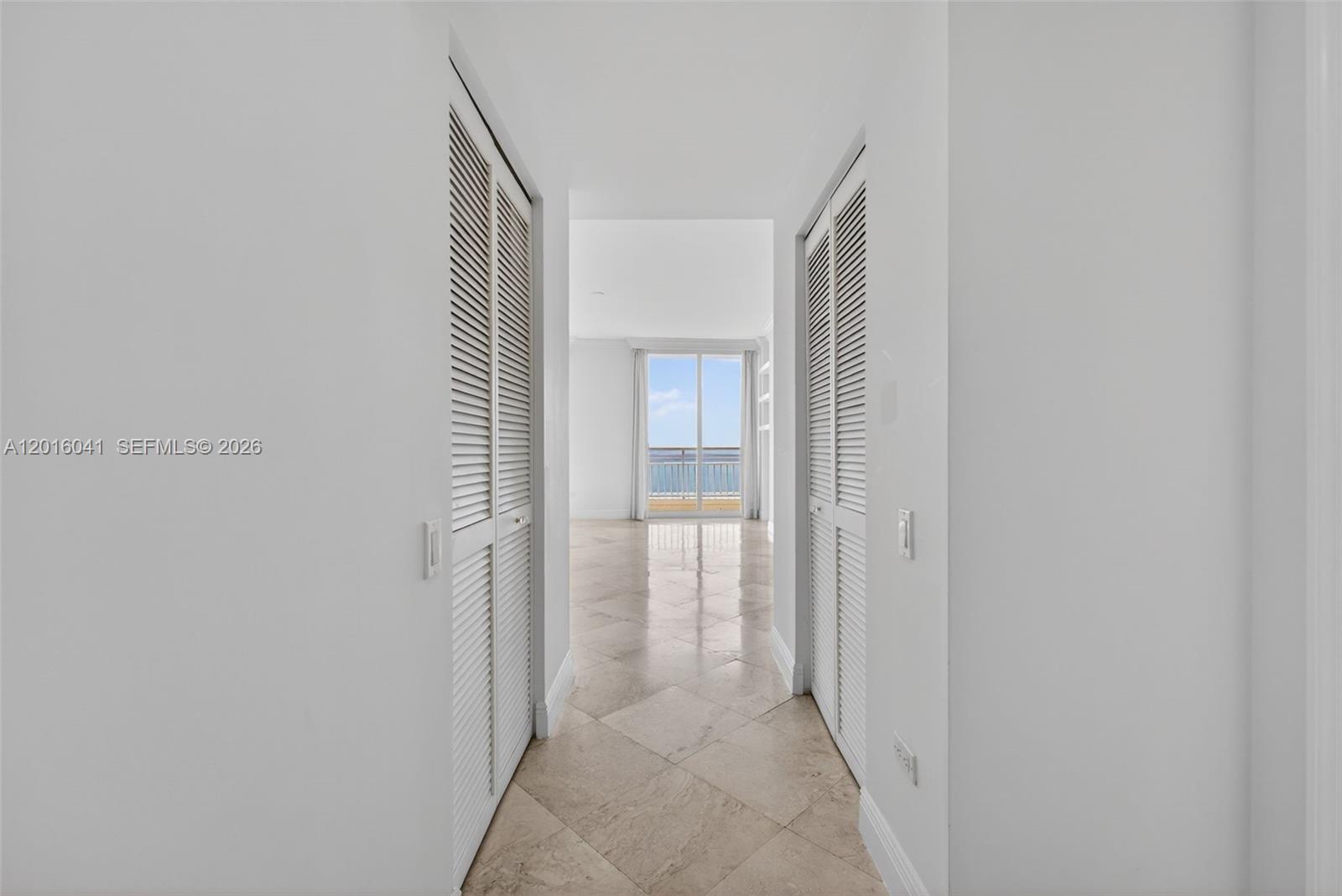 808 Brickell Key Drive, Unit 3304 Miami, FL 33131 - Photo 44 of 70 a view of a hallway with wooden floor and a bathroom