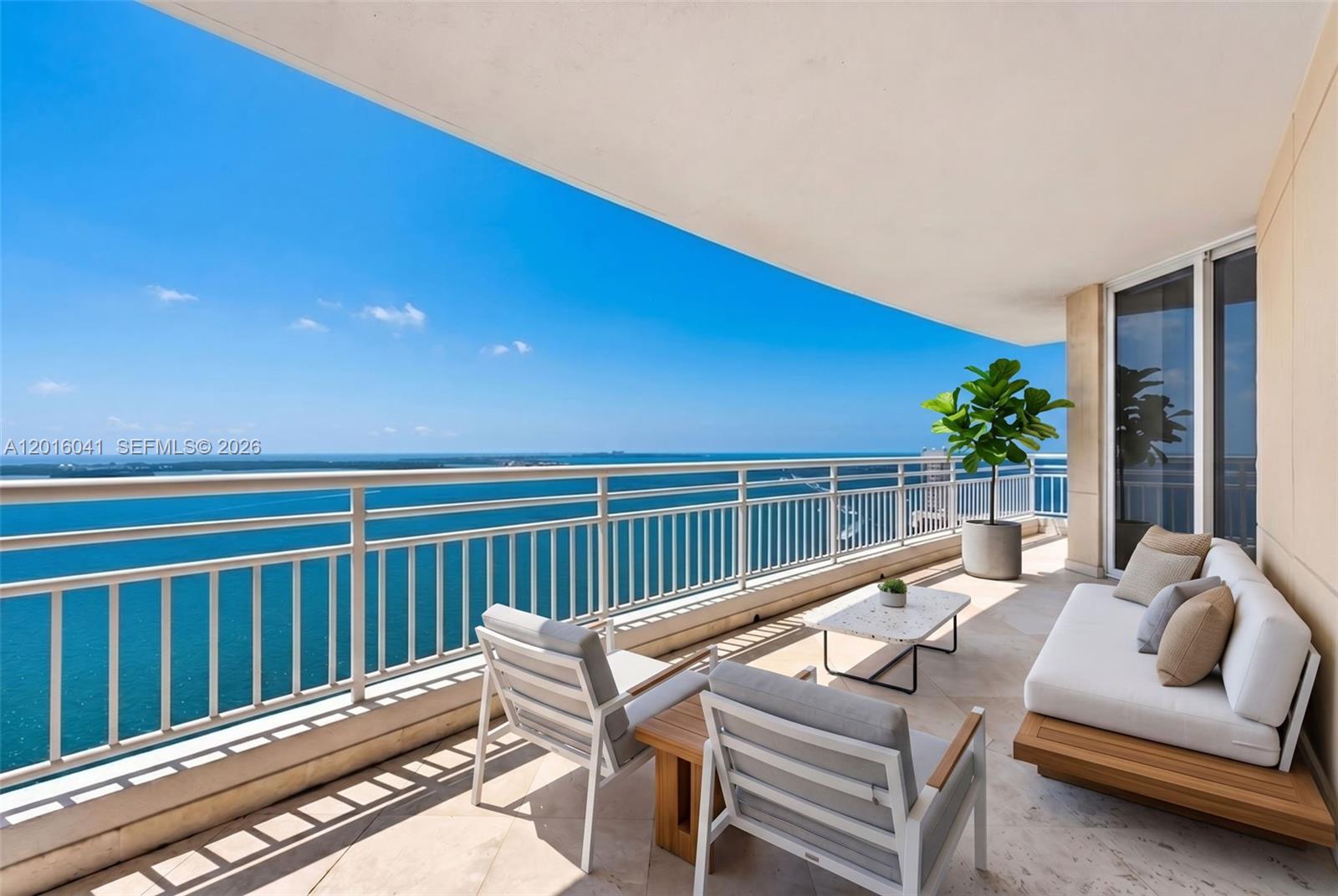 808 Brickell Key Drive, Unit 3304 Miami, FL 33131 - Photo 55 of 70 a view of a patio with a table chairs and a backyard