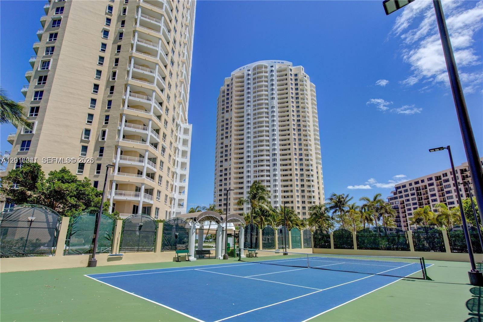 808 Brickell Key Drive, Unit 3304 Miami, FL 33131 - Photo 65 of 70 a view of a tall building next to a yard
