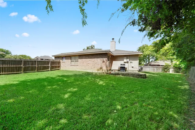 a view of a house with a backyard porch and sitting area