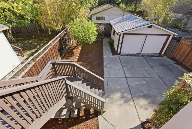 a view of a roof deck with couches and sky view