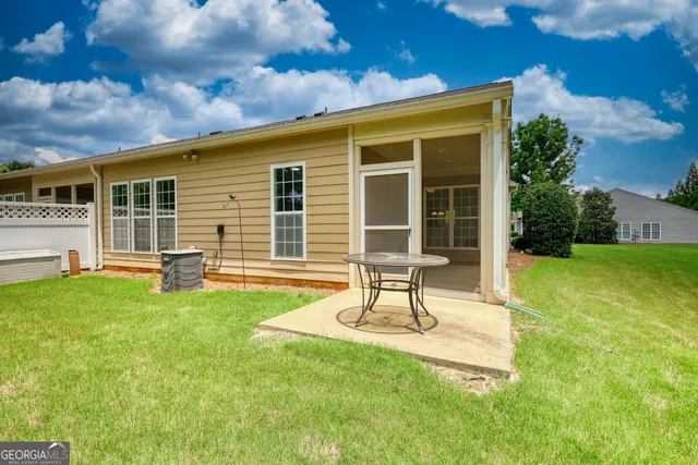 a house view with a sitting space and garden