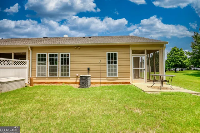front view of a house with a yard and a table