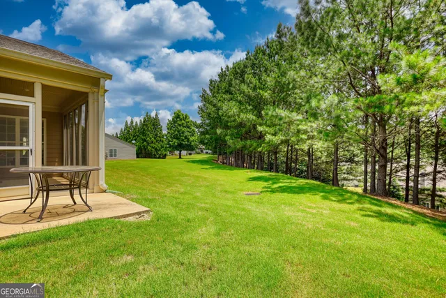 a view of a backyard with a garden and entertaining space
