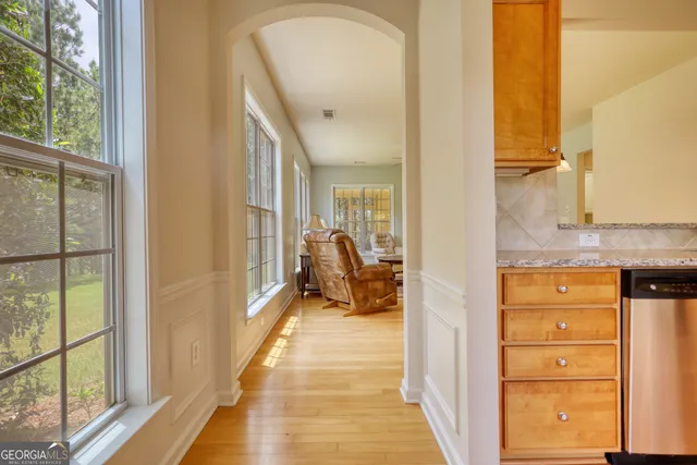 a hallway with cabinets and wooden floor