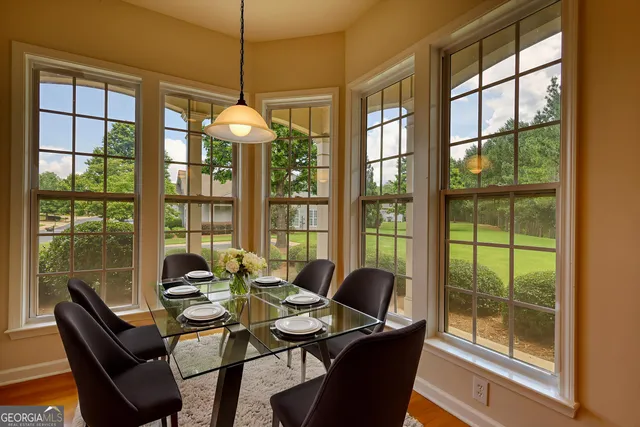 a dining room with furniture a chandelier and glass door
