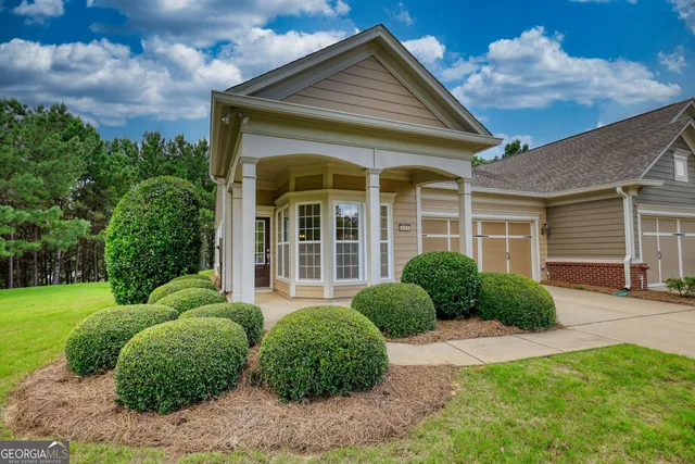 a view of a house with a garden and plants