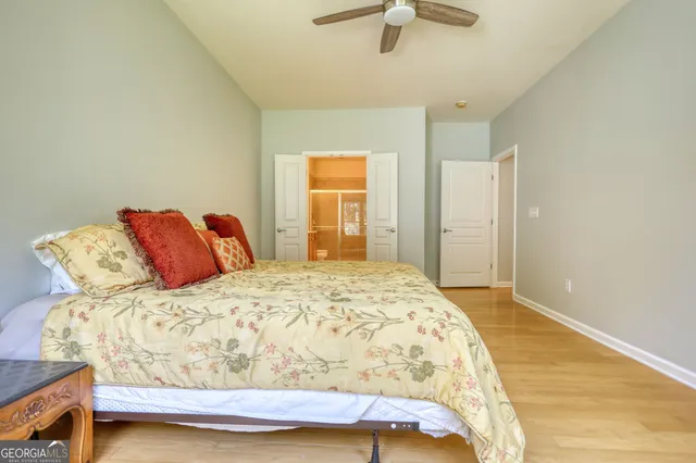 a bathroom with a double vanity sink a toilet and shower