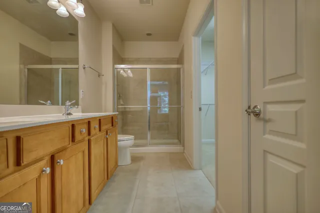 a bathroom with a double vanity sink mirror and toilet