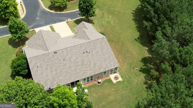 an aerial view of a house with a yard and lake view