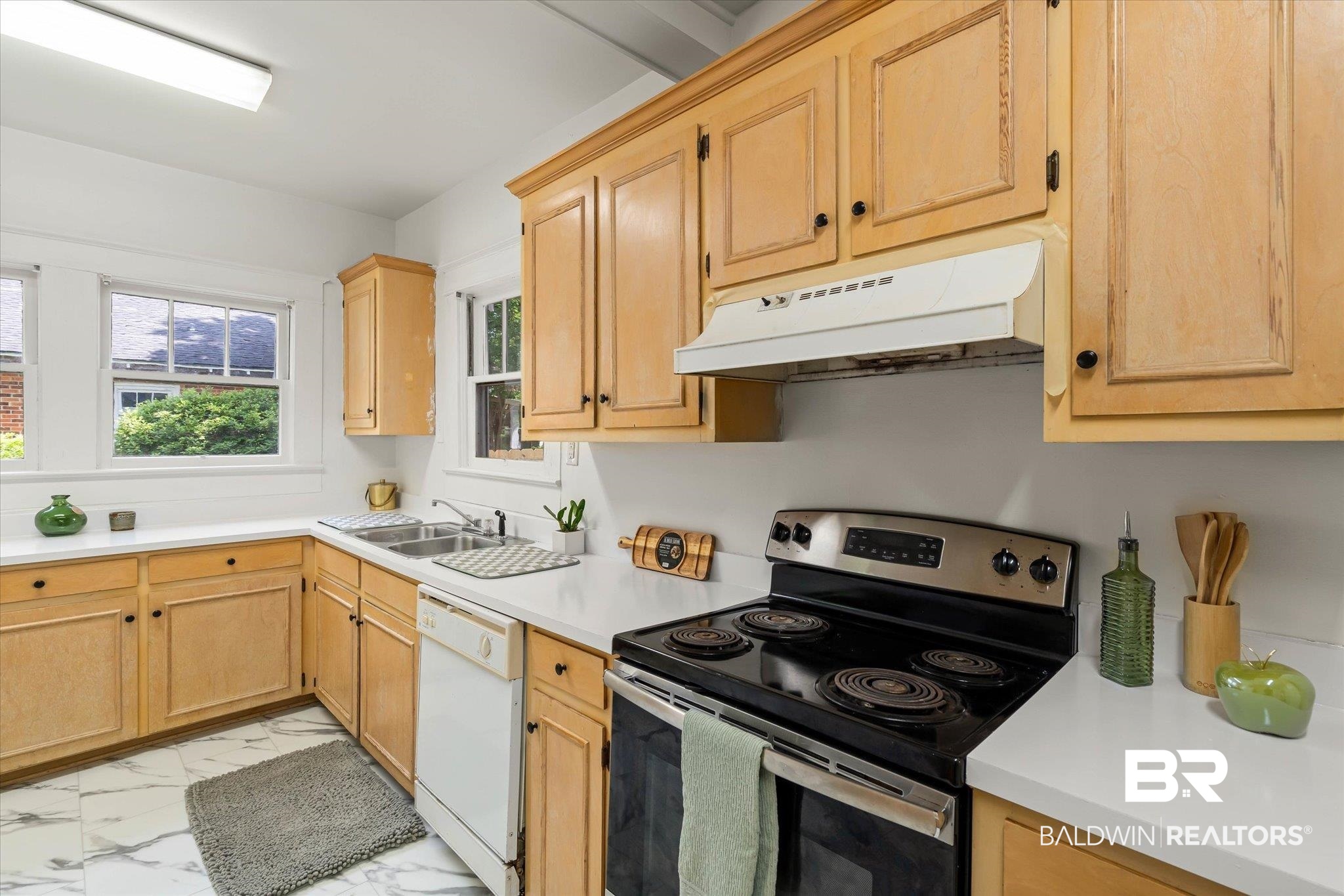 121 Westwood Street Mobile, AL 36606 - Photo 6 of 20 Kitchen featuring marble finish floor, under cabinet range hood, a sink, white dishwasher, and stainless steel electric range oven