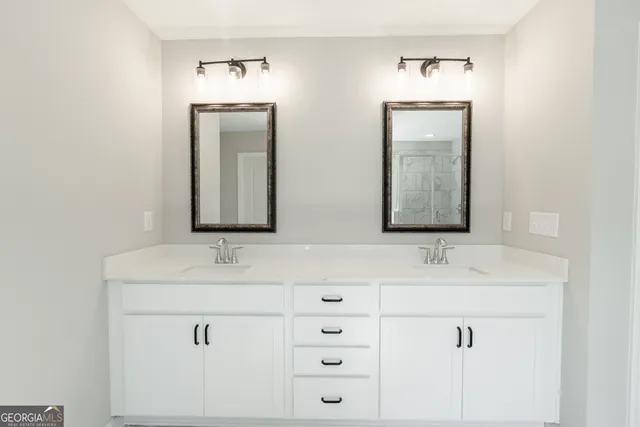 a bathroom with a double vanity sink and mirror