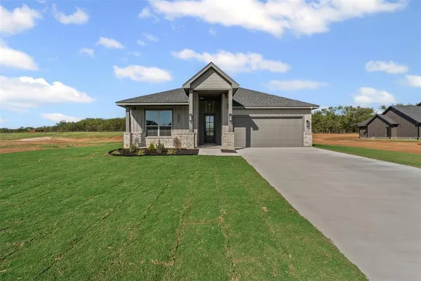 a view of a house with a yard and sitting area