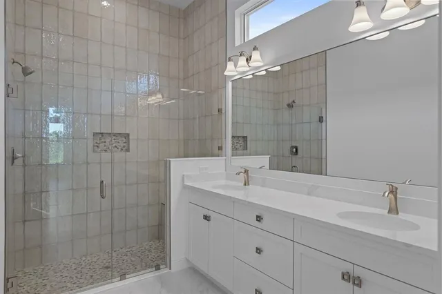 a bathroom with a shower sink and mirror
