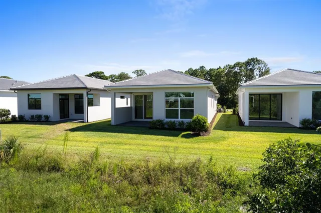 a view of a house with a swimming pool and a yard